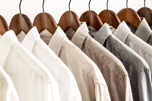 Several Shirts On A Hanger From White To Black Color Range